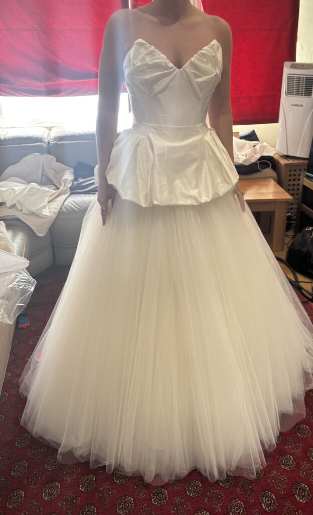 Final fitting of a Vivienne Westwood Raven corset top with a Bridal Rouge Gallery skirt before the wedding front view.