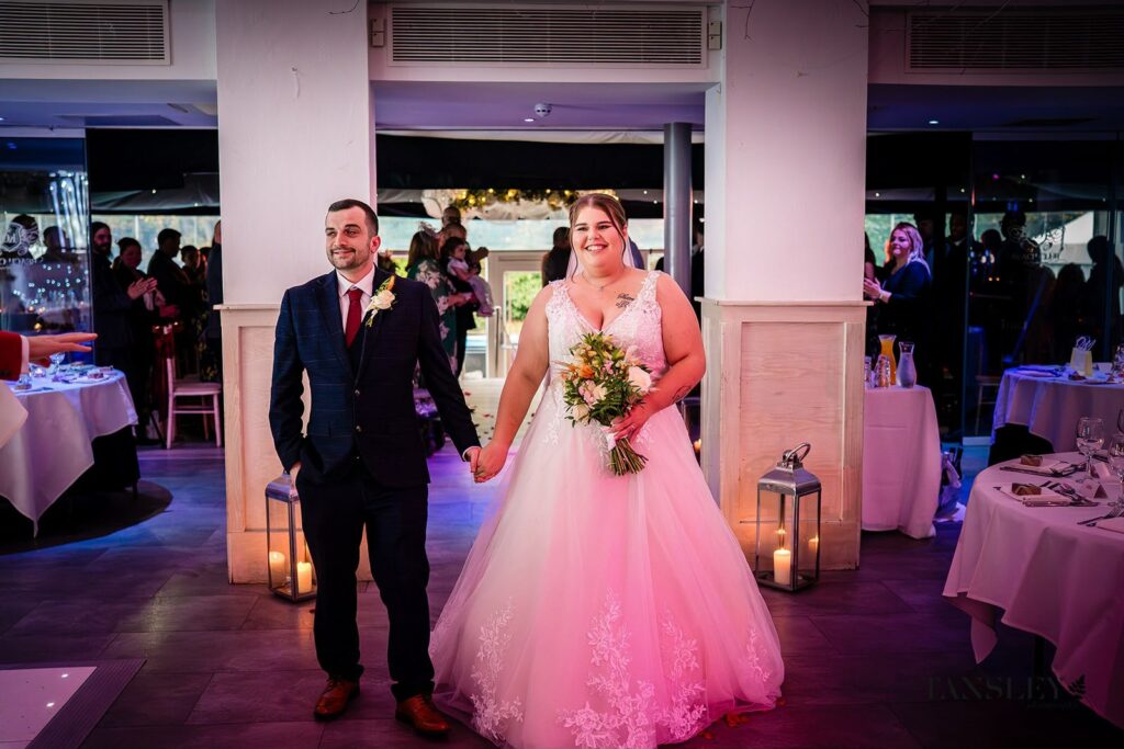 Wedding Dress Alterations Essex by couture bridal alterations specialist groom and bride walking hand in hand.