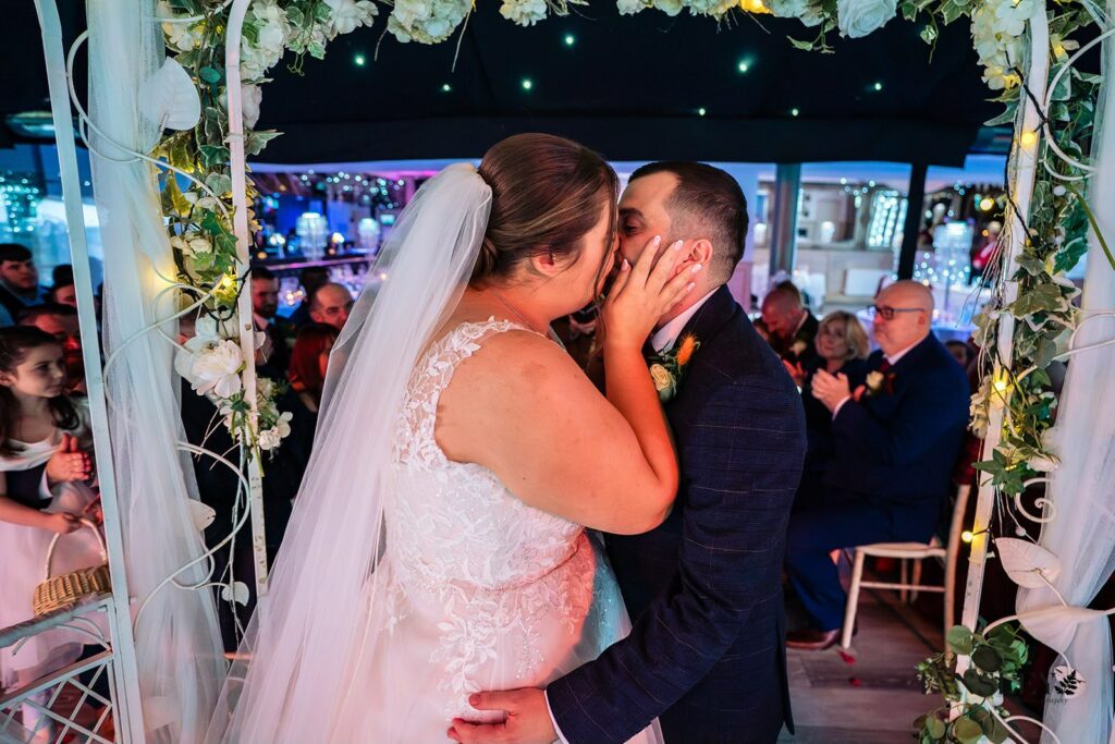 WED2B Marianna wedding dress alterations for a bride from Chigwell Essex bride and groom kissing.