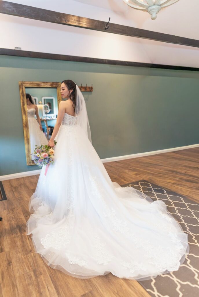 Pregnancy Wedding Dress Alterations Bride wearing the lace ceremony dress after the neckline transformation.
