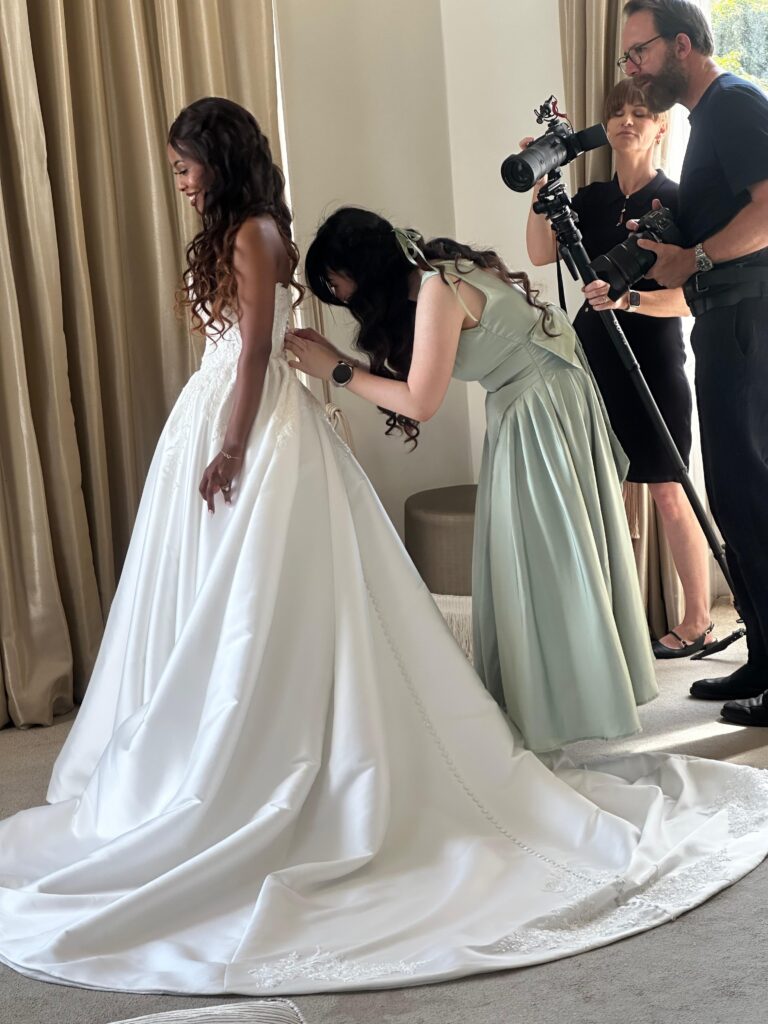 bridesmaid closing back buttons on the day.
