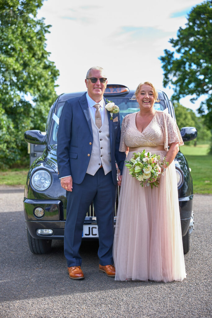 Carshalton bride Jo wearing her altered beaded blush wedding dress with the groom walking hand in hand.