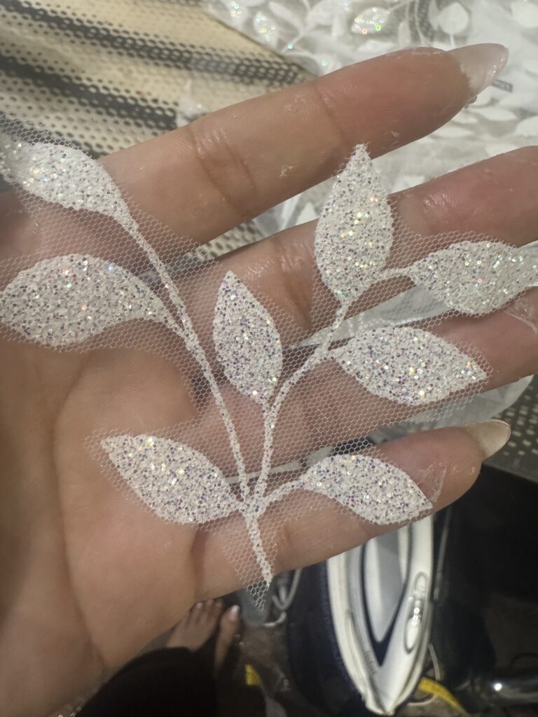 Adding sleeves to a wedding dress with bespoke glittered leaf fabric bridal sleeves created from the original gown hem remnants 
