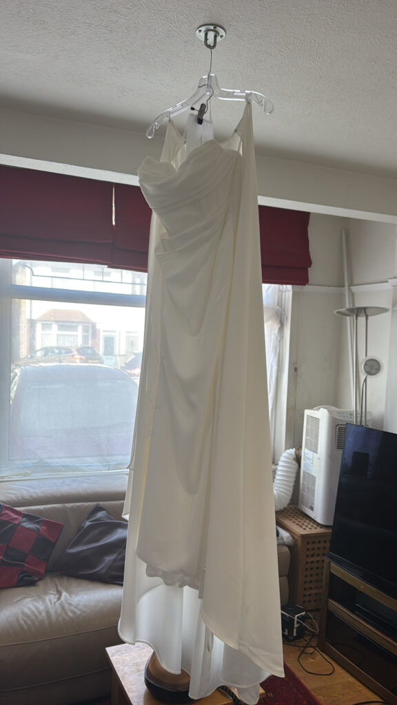 Professionally steam pressed satin wedding dress after couture bridal alterations