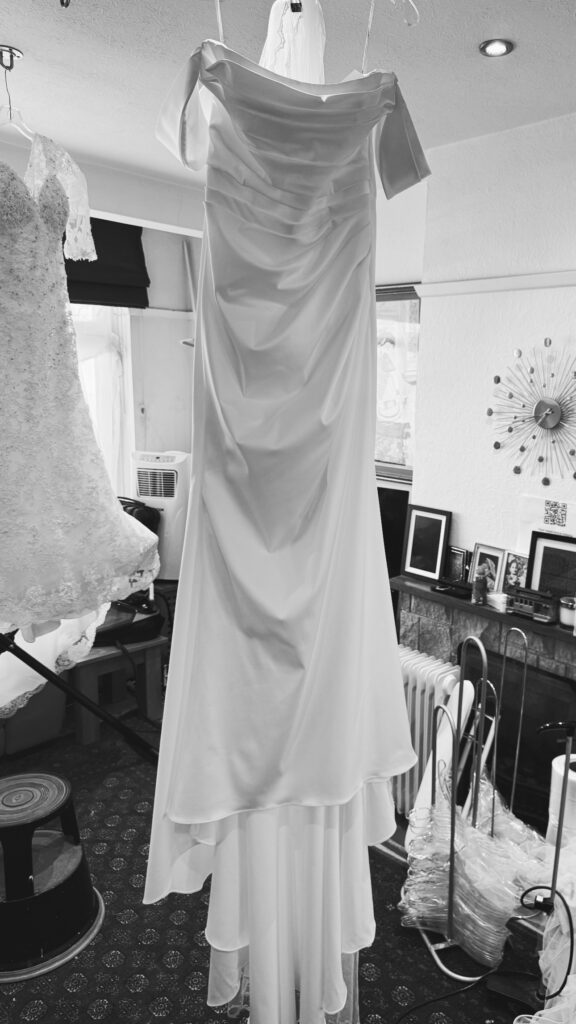 final steam pressing of Bridal dress and veil at collection.