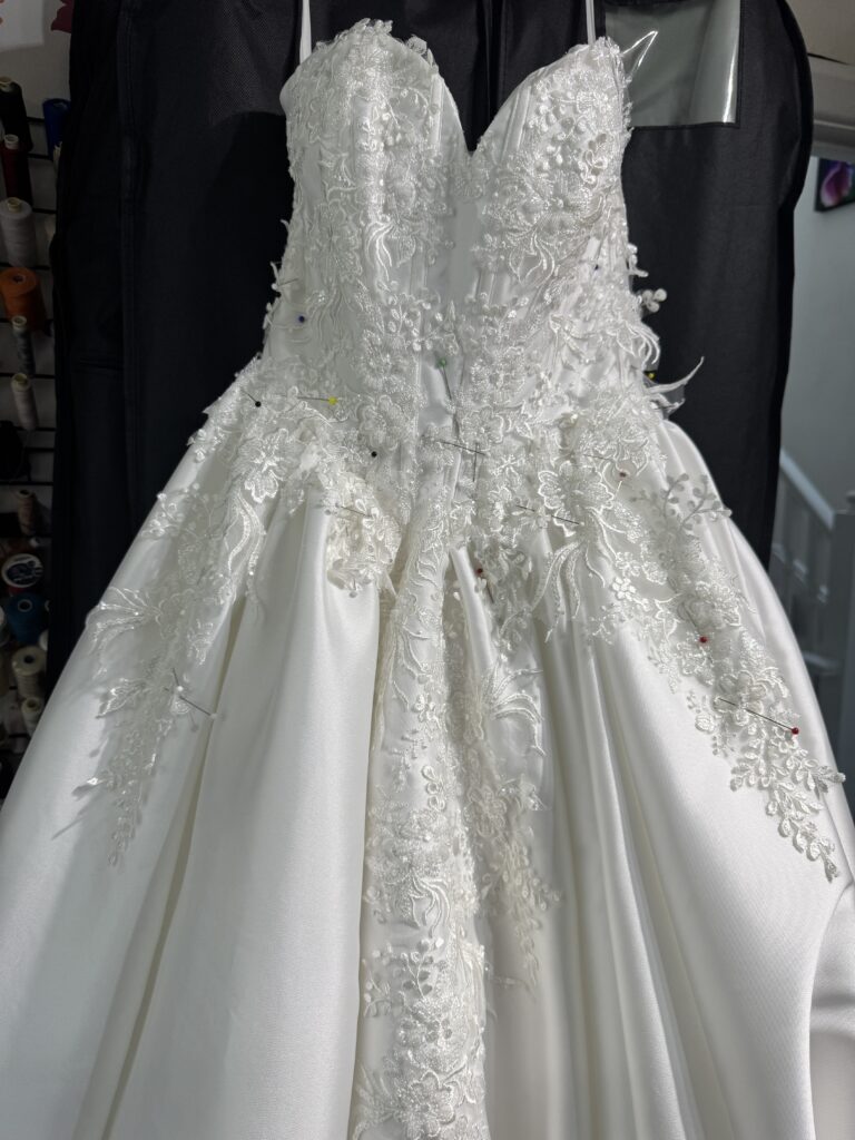 Front details of lace applique Uxbridge bridal alterations all hand sewn with tiny back stitches all over Uxbridge bridal alterations for a completely transformed WED2B Jules wedding dress.