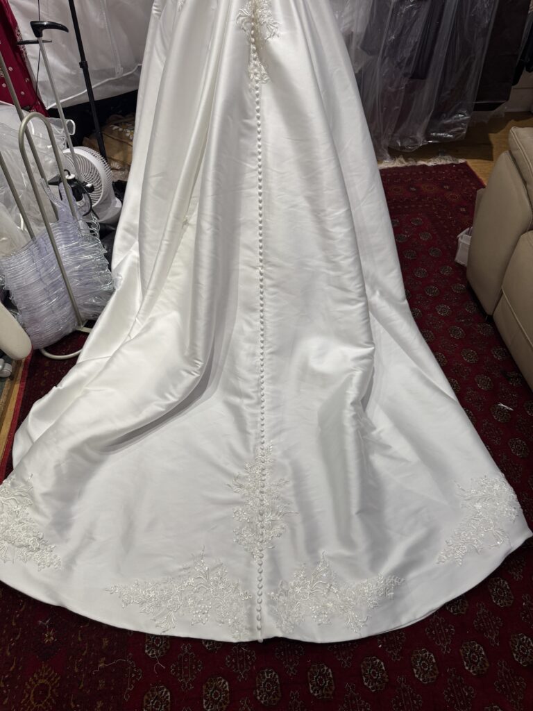 hem detail on train lace applique stitched under buttons to make it look all well blended and perfect.