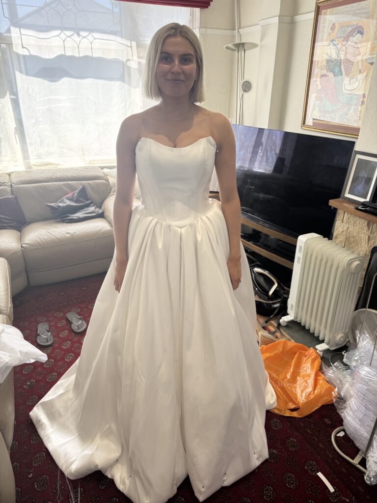 Tooting bride Bethan wearing her Stella York wedding dress pinned to size at first fitting.