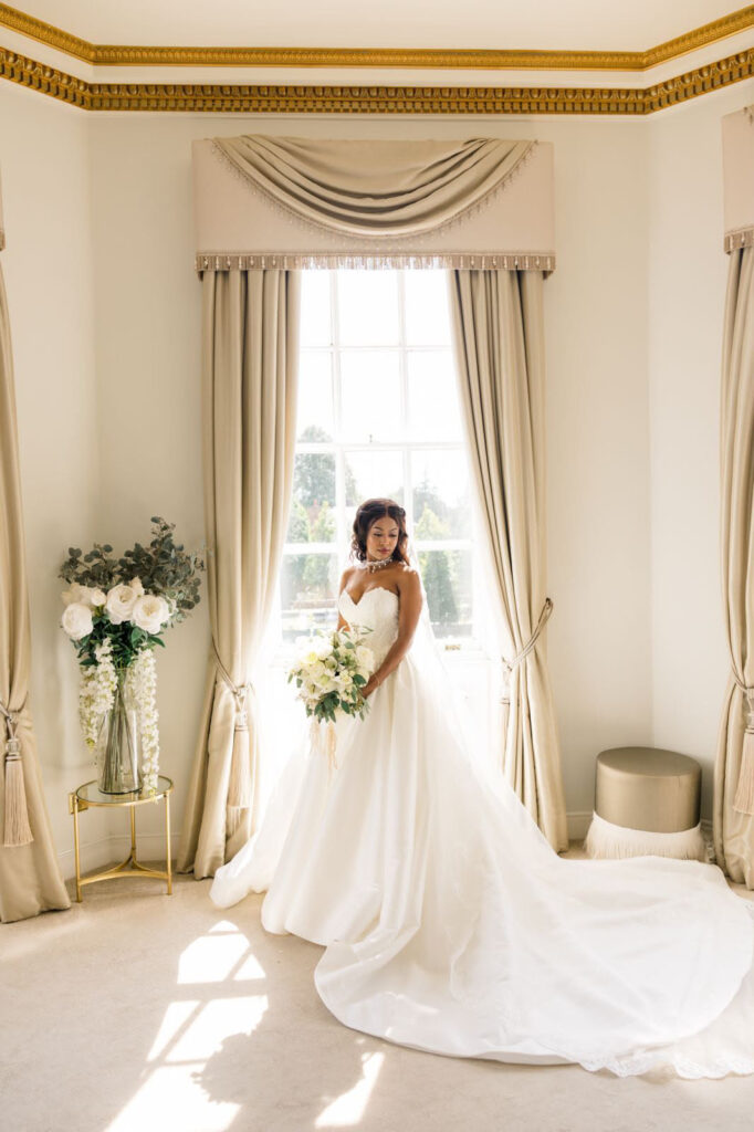 bride wearing her dress during ceremony while getting ready.