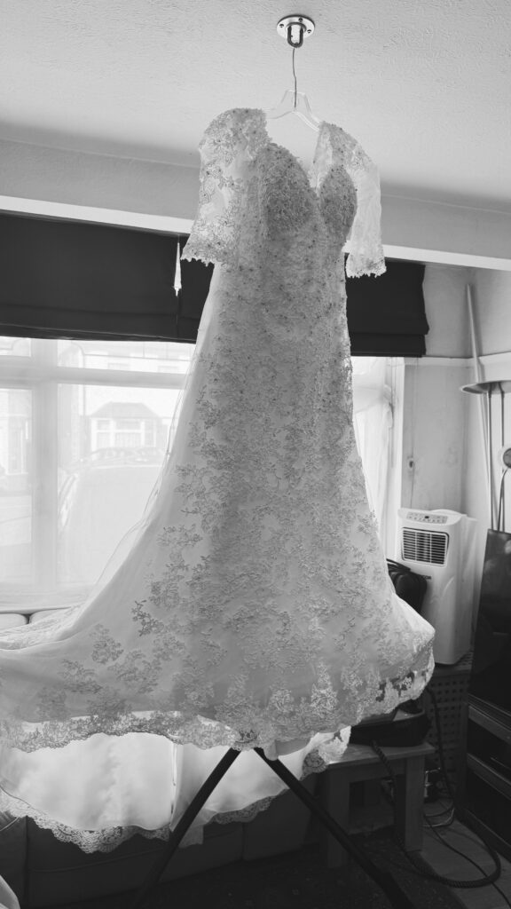 Intricate floral lace border preserved during wedding dress hem alterations and a full professional steam press given before collection.