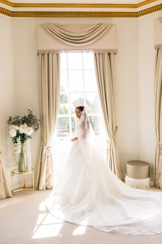 cathedral veil and long train of the WED2B Jules ball gown shown beautifully in this picture.
