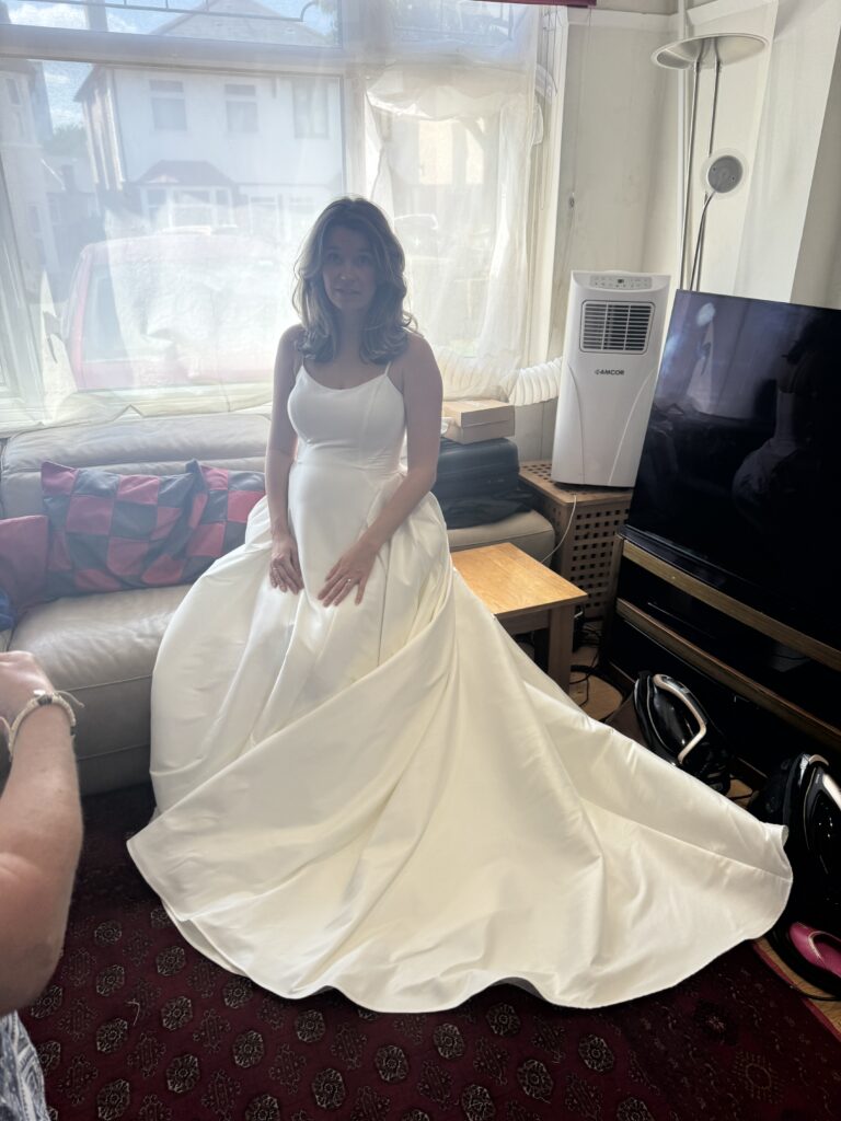 Pregnant bridal alterations Carshalton sitting down to test straps. 