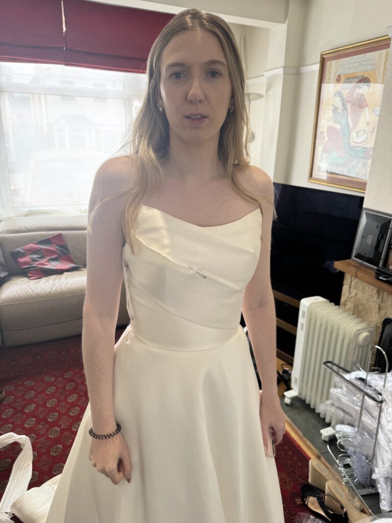 Leatherhead bride Beth wearing her Allure Carmena satin wedding dress original pinned at first fitting.