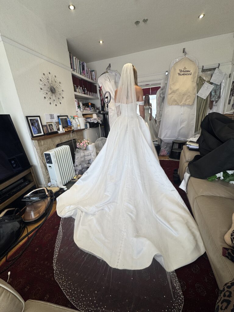 Finished bridal alterations for Molesey bride in structured satin wedding dress by a couture specialist in Surrey.