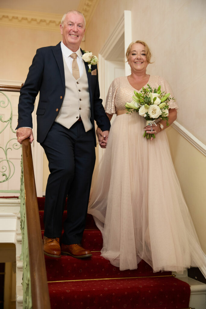 Carshalton bride Jo wearing her altered beaded blush wedding dress with the groom looking happy