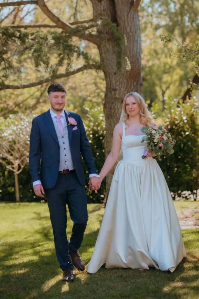Bride wearing House of CB wedding dress after bust and waist alterations
