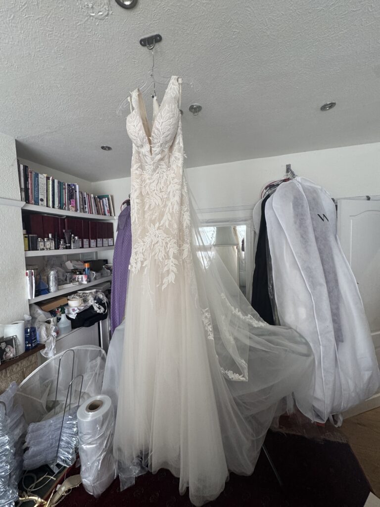 zip completely removed of her Daria Karlozi Kristavera wedding dress
To take it in by 10cm all along top to knee.