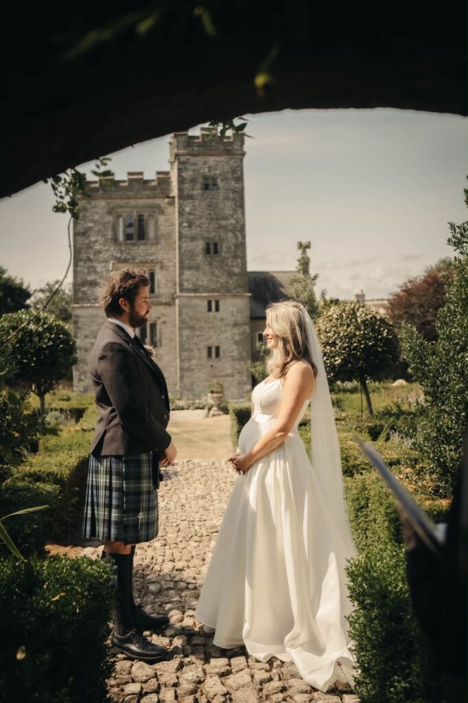 Pregnant bridal alterations Carshalton bride and groom at their intimate Pengersick Castle wedding in Cornwall