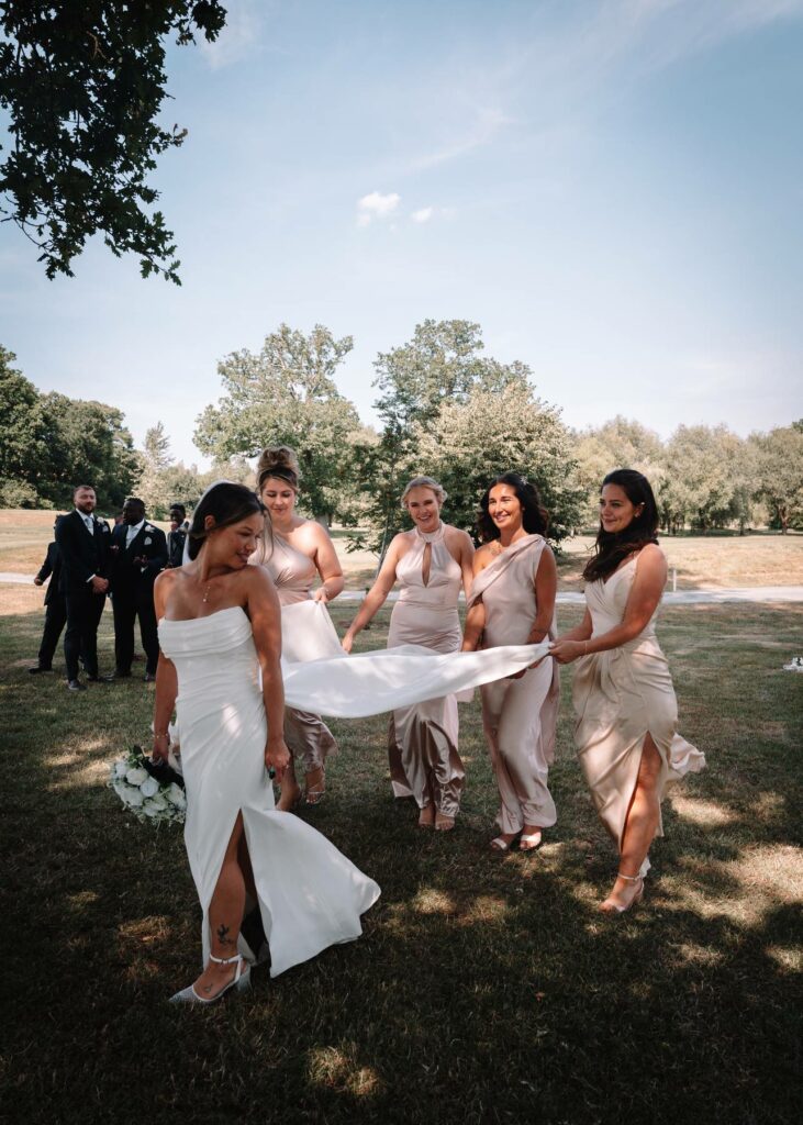 Bridesmaids arranging the Wallington bride’s altered detachable wedding dress train