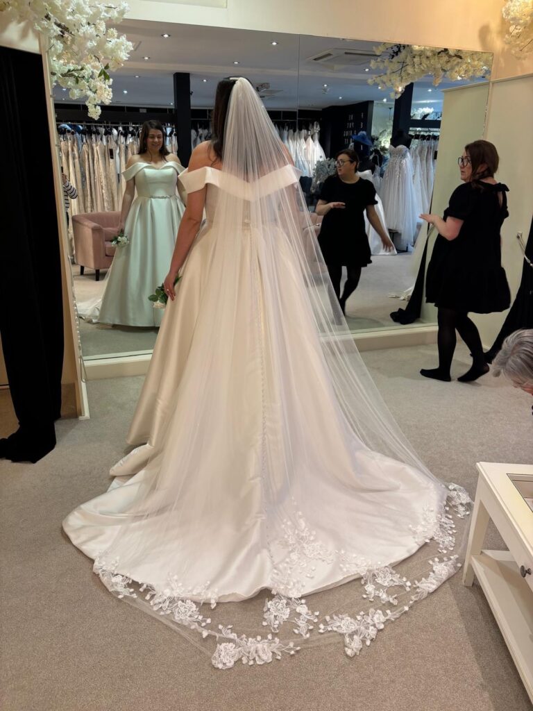 bride at Aurora bride trying on her dress before weightloss.