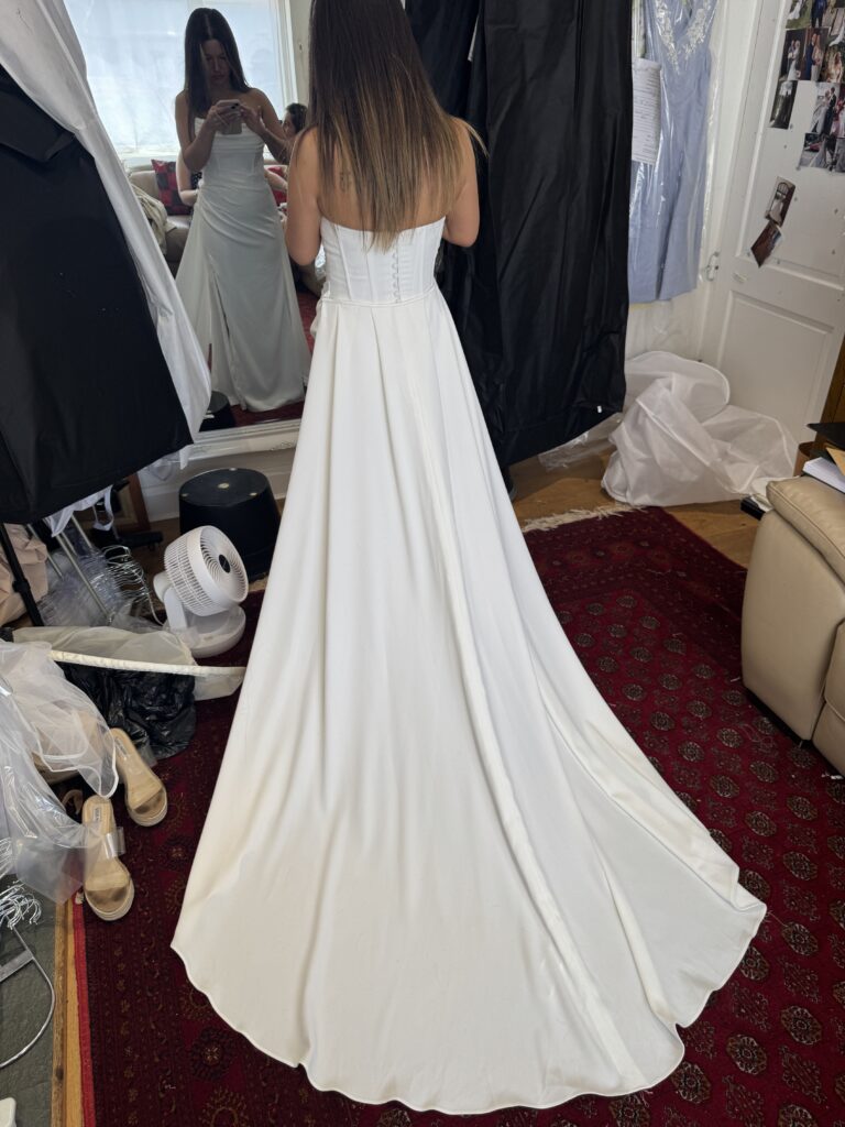 Wallington bride after weight loss with professionally altered satin wedding dress final dress fitting back detachable train view at my Studio in Sutton.