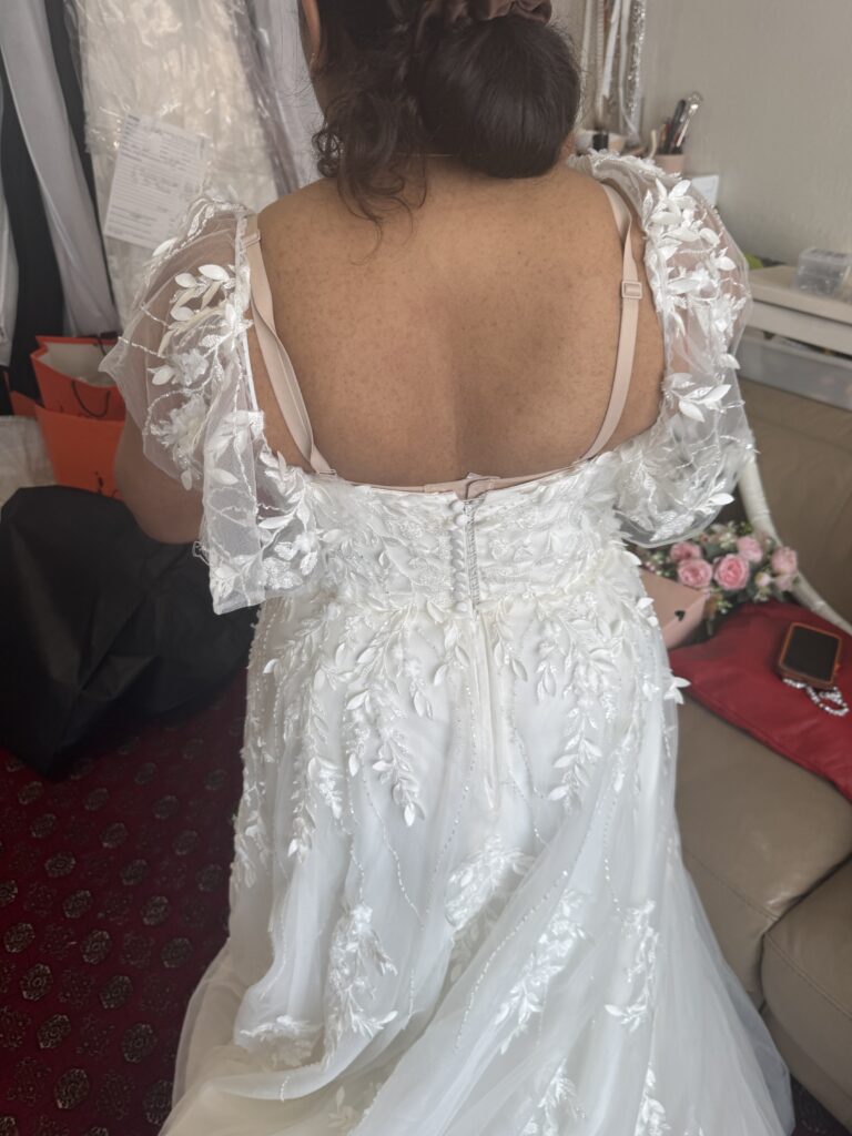 Hayes wedding dress alterations on an Essense of Australia D3529 gown with a redesigned back lace neckline and illusion shoulders before alterations.