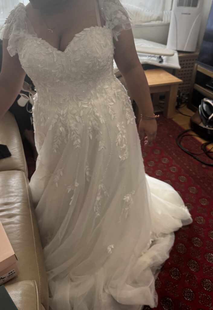 Hayes wedding dress alterations on an Essense of Australia D3529 gown with a redesigned lace neckline front view before alterations.