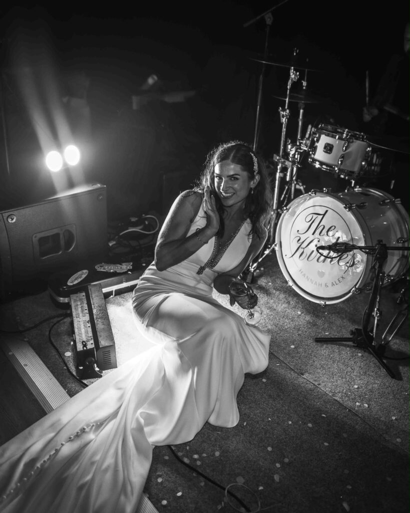 bride seated in her wedding dress looking regal with train.
