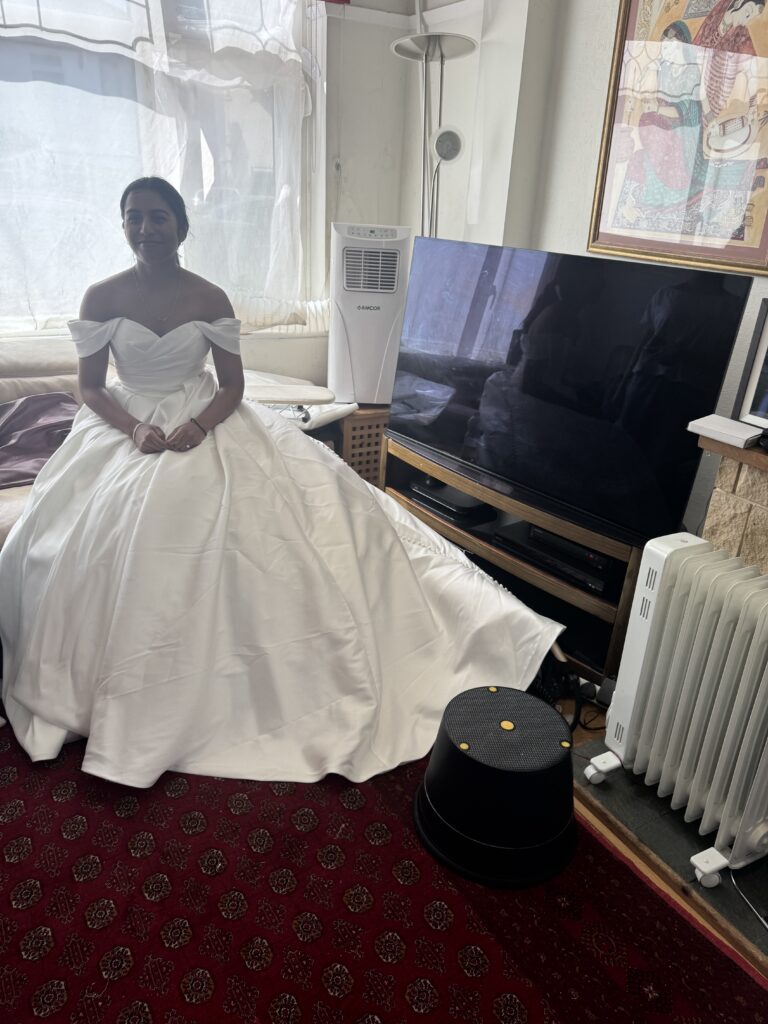 seated Bride wearing her WED2B Sofia Cruz Jade gown during a fitting in Sutton for Hayes and Pinner bridal alterations.