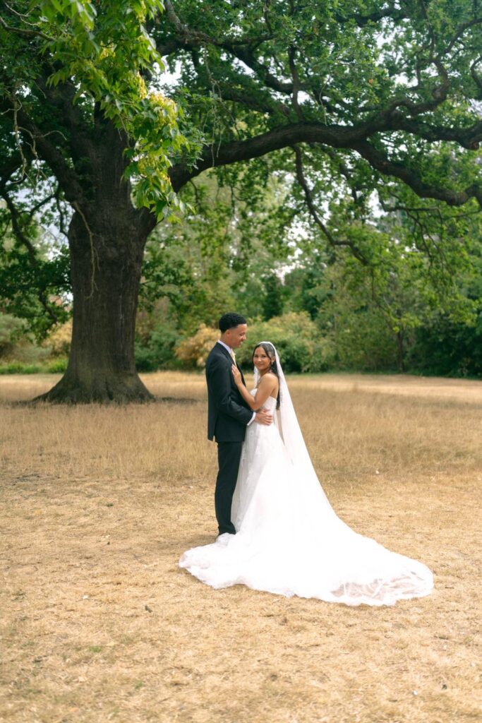 Bride wearing an Anna Sorrano Mercia lace wedding dress with groom