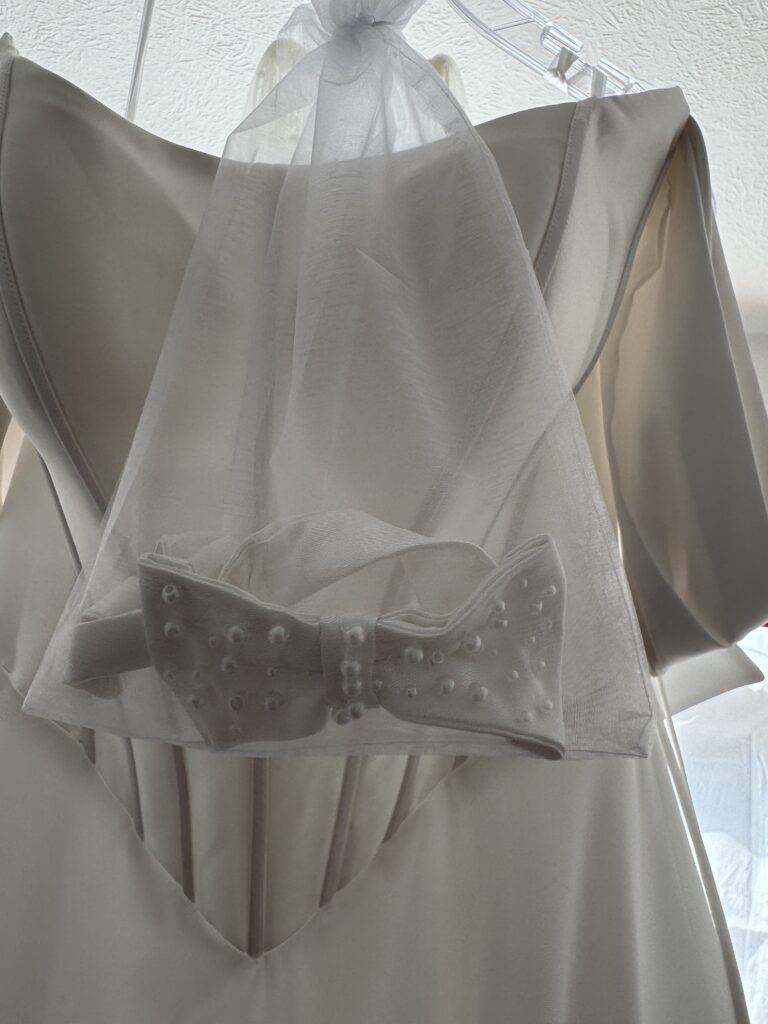 bow made of hem remnants from bride’s dress.
