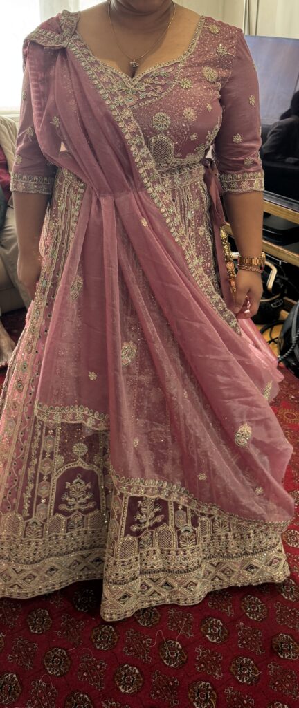 Hayes bride wearing her completed dusty rose embroidered lehenga and supportive fitted choli