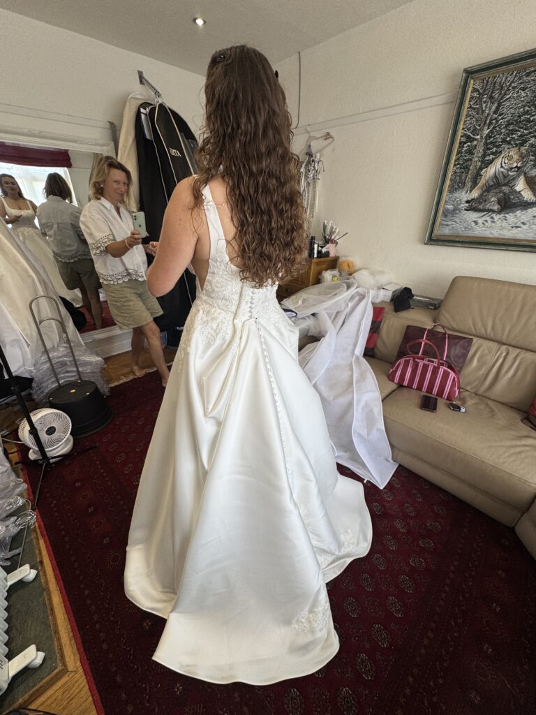 first fitting Stella York wedding dress alterations for a Bromley bride with the embroidered beaded lace with buttons all along centre back.