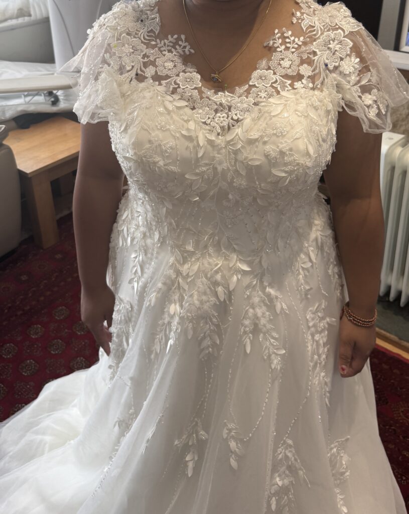 Hayes wedding dress alterations on an Essense of Australia D3529 gown with a redesigned front lace neckline and illusion shoulders after couture alterations.