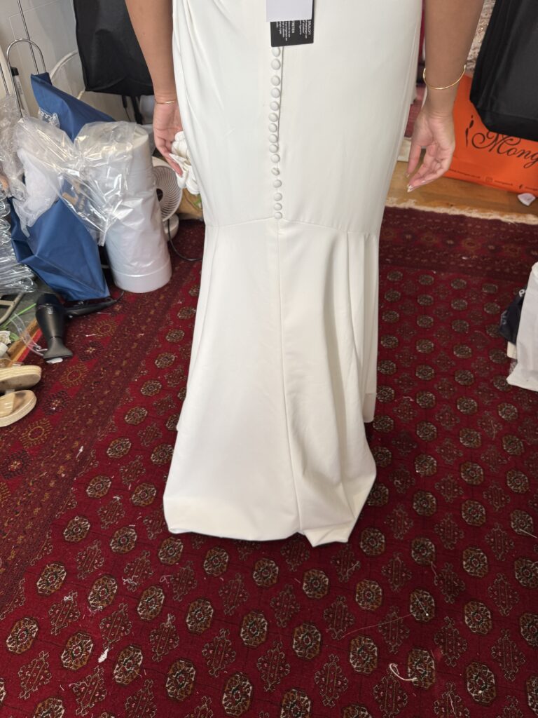 Three point under bustle called ballroom bustle installed to help bride dance all night at her wedding.