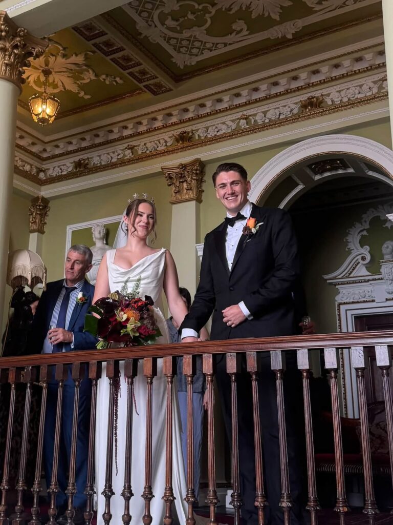 Streatham bride wuth her groom on wedding day standing on a balcony 