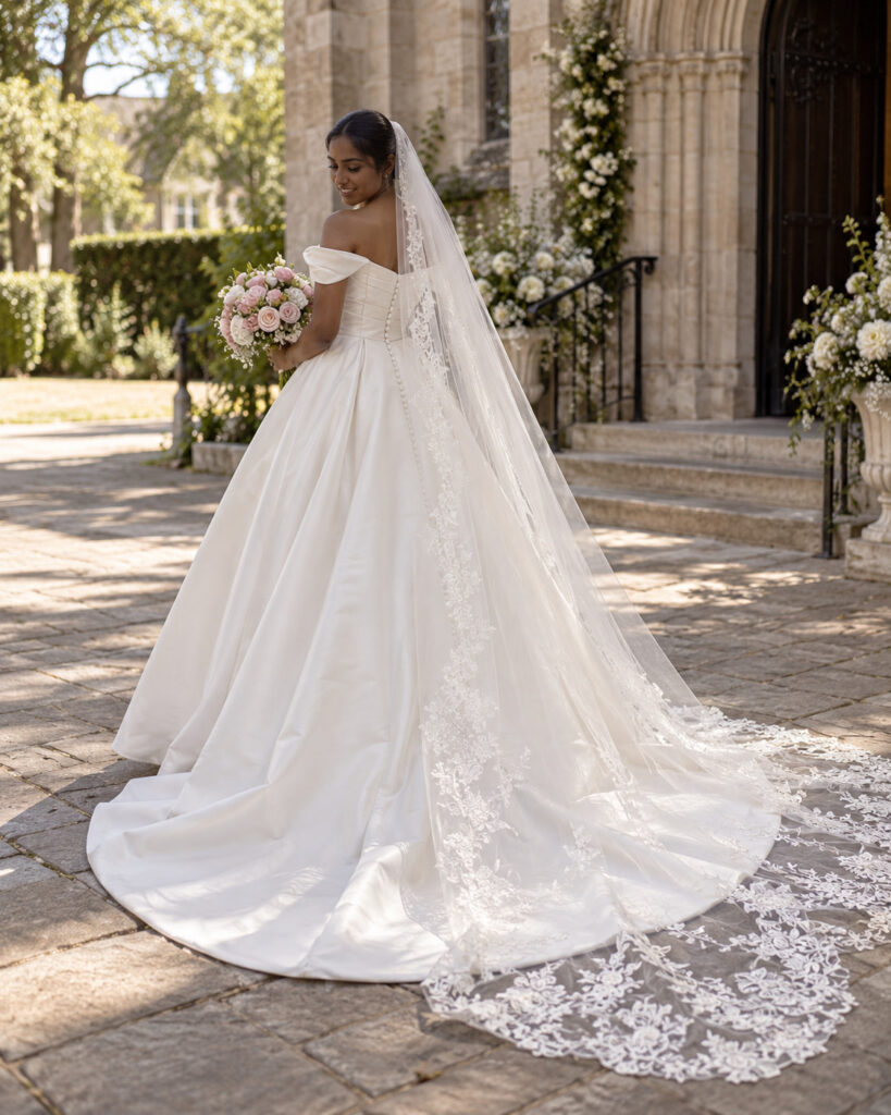 lace edged cathedral veil framing dress at ceremony 