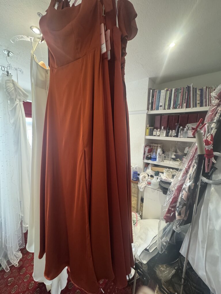 Rust coloured bridesmaids seven dresses all steam pressed and ready.