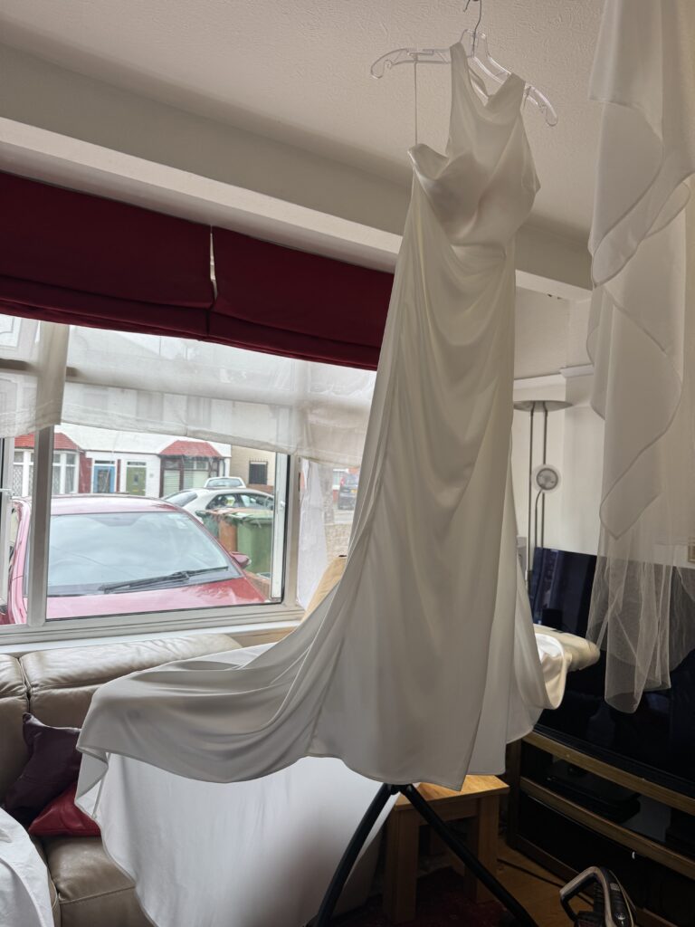 steam presses wedding dress, cape and veils.