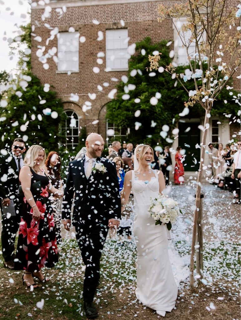 bride wearing her dress on the wedding day with groom during ceremony.