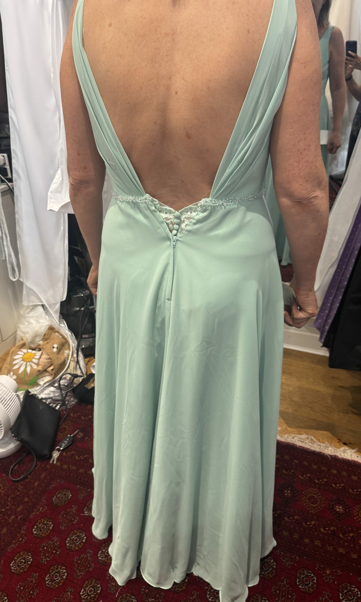 back closure redesigned to accommodate bridesmaid’s body measurements.