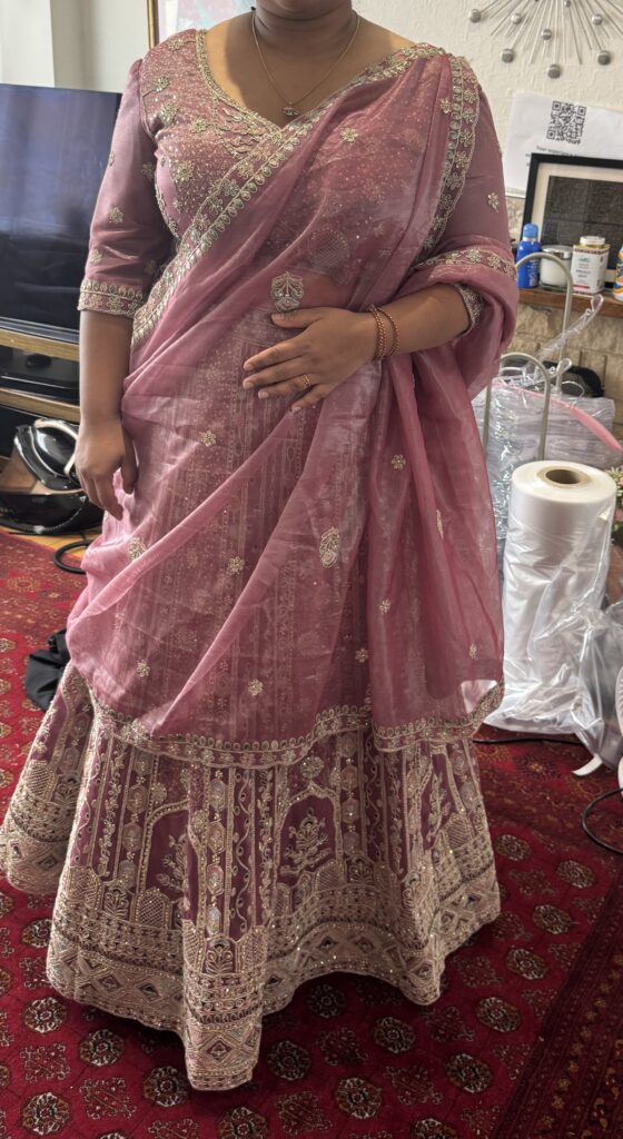 Hayes bride wearing her completed dusty rose embroidered lehenga and supportive fitted choli perfect fit.