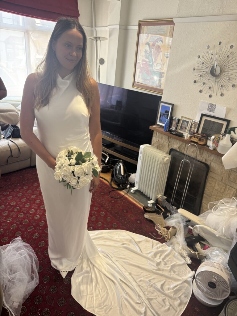 Grace Loves Lace Bridal alterations bride wearing her dress at final fitting.
