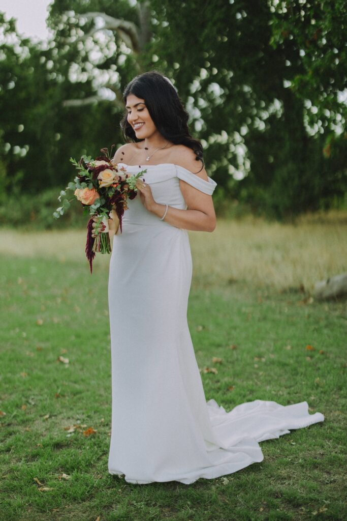 Bride wearing her bridal dress showing the full it in a natural wedding setting