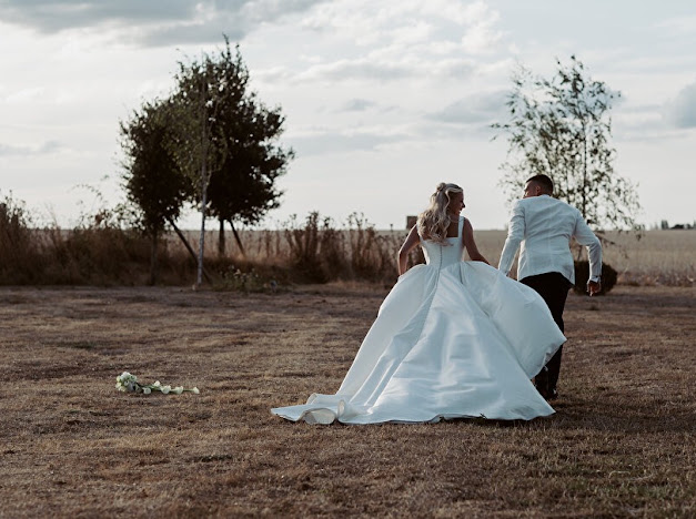back view of couple walking away hand in hand