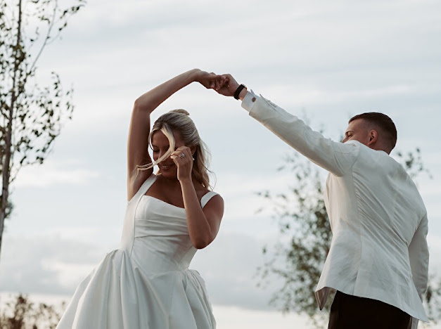 Groom twirling the bride in her Milla Nova Ermana wedding dress outdoors