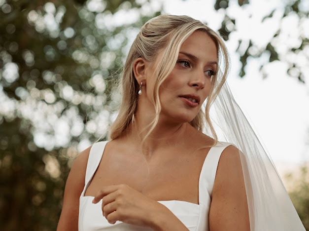 Close-up of the bride from Carshalton showing the Ermana gown’s draped neckline and wide shoulder straps of her skilfully altered Milla Nova Wedding dress alterations 