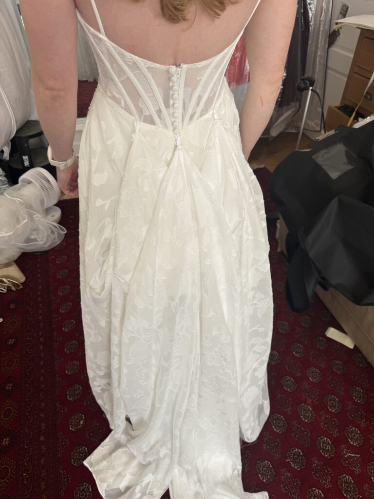 back view of fitting showing 3 point American Bustle made after alterations.