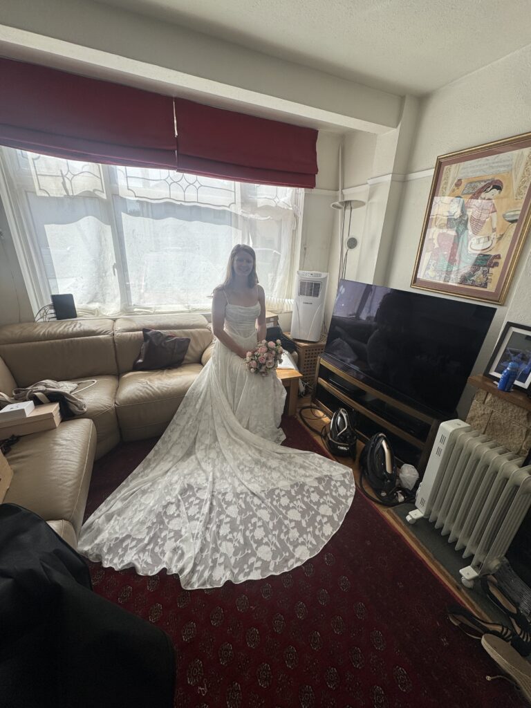 Train view of bride’s dress wearing Stella York 8055 with its floral train spread out.