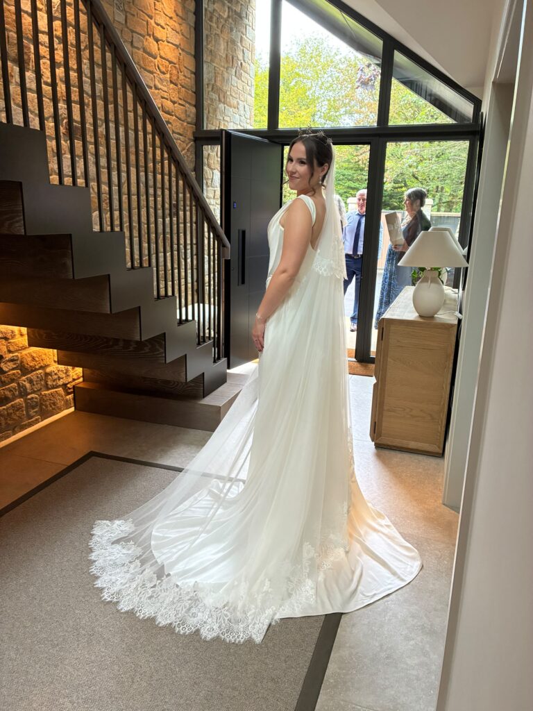 Back of Vivienne Westwood Nova Grace gown with detachable train and lace veil